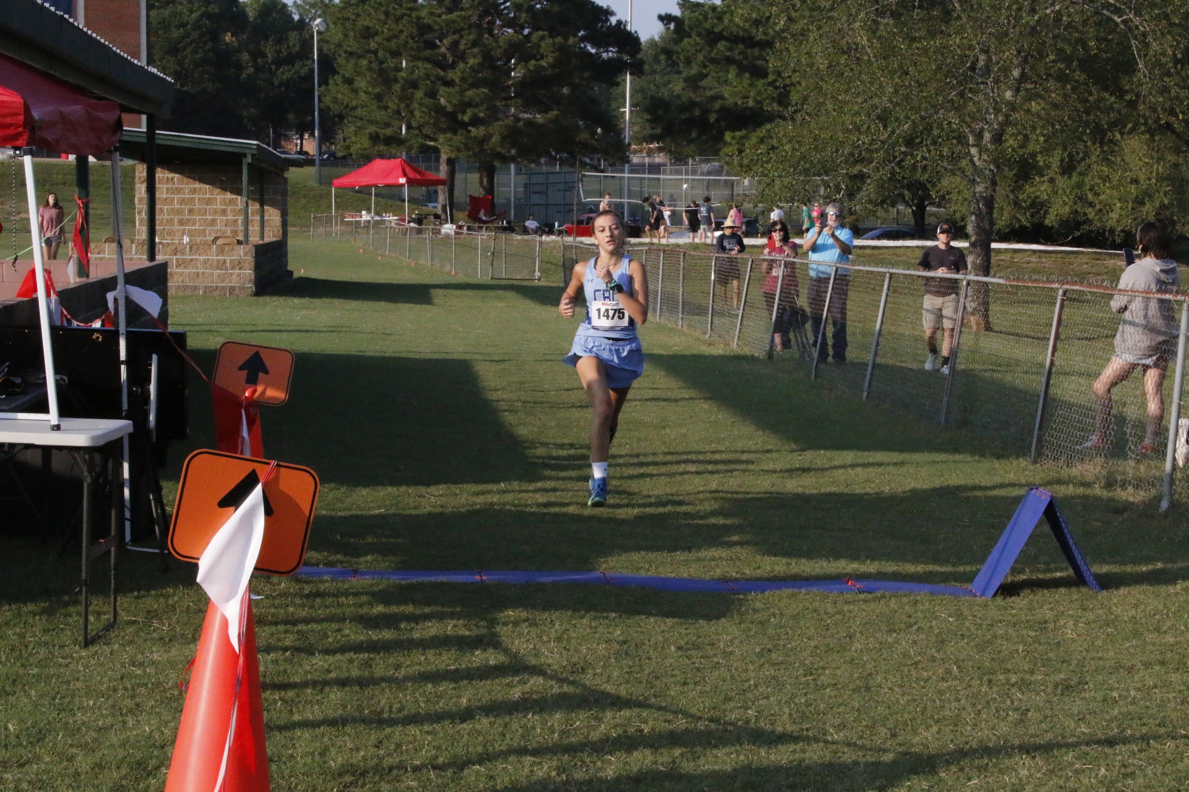 Mackenzie Milligan crosses the finish line at the Lyon Invitational